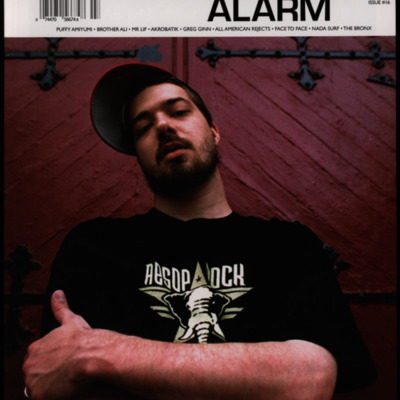 Magazine cover with image of an artist posing in front of a door.