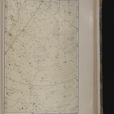 Printed map of the location of stars in the sky, with dotted lines dividing the constellations