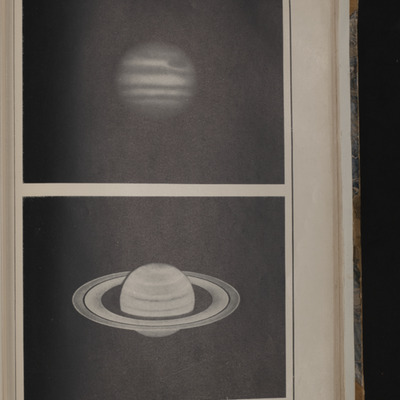 Printed photographs of the planets Jupiter and Saturn